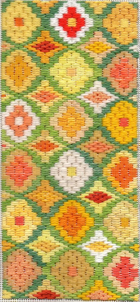 a green and yellow rug with flowers on it