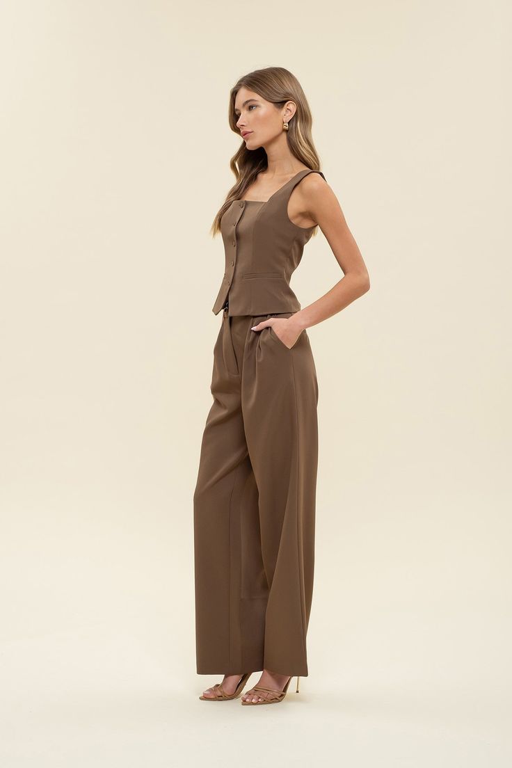 Office chic to date night to weekends looking cutie while on-the go, dress to impress in our Greenwich pleat trousers. These high-waisted pants feature a hook and eye closure, belt loops, back pockets, slick side pockets, pleated detailing, a wide leg with a flared hemline, and let's not forget they are the color of the season - chocolate BROWN! Designed in the USA. Imported Fabric Content: 88% Polyester, 12% Spandex. Inner Lining: 100% Polyester Model is 5'6 and is wearing a size Small. Chic Tailored Pantsuit With Belt Loops, Chic Belted Pants For Day Out, Chic High-waisted Dress Pants For Date Night, Chic Wide-leg Dress Pants For Date Night, Chic Wide Leg Dress Pants For Date Night, Chic Belted Bottoms For Date Night, Belted Bottoms For Date Night, High-waisted Pants With Belt Loops For Date Night, Chic Tailored Wide Leg Pants With Belt Loops