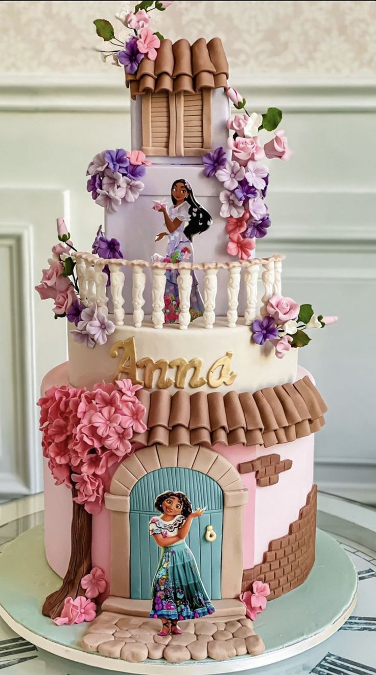 a three tiered cake is decorated with flowers and an image of princess on top