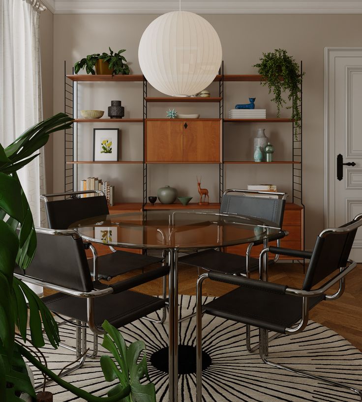 a glass table with chairs around it in front of a book shelf and potted plant