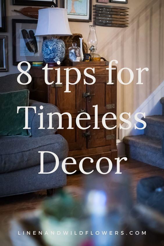 a living room filled with furniture and pictures on the wall next to a wooden dresser