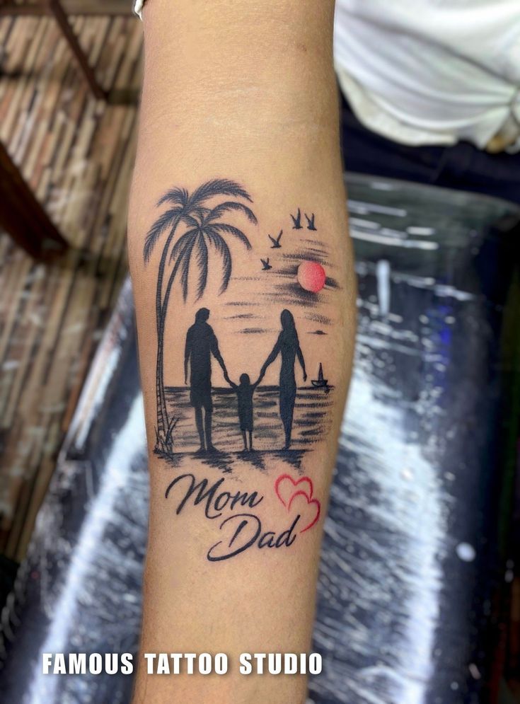 a tattoo on the arm of a man and woman holding hands, with palm trees in the background