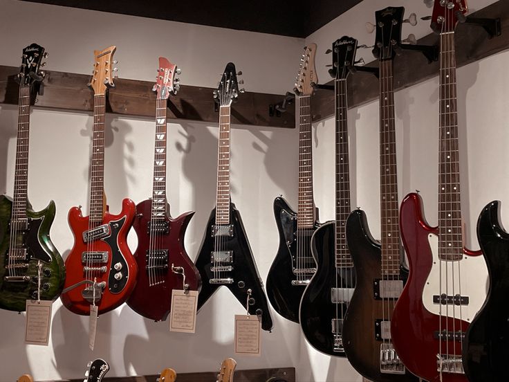 guitars are lined up on display in a room