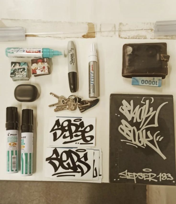 the contents of an art supply bag are neatly organized and displayed on a countertop