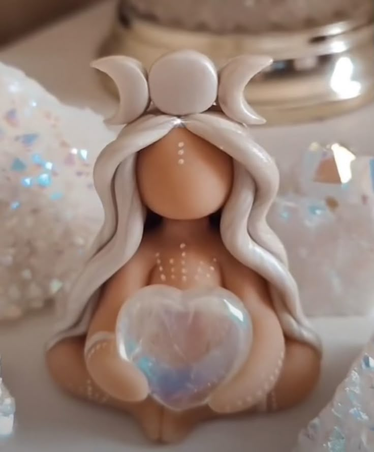 there is a figurine that looks like a woman holding a heart