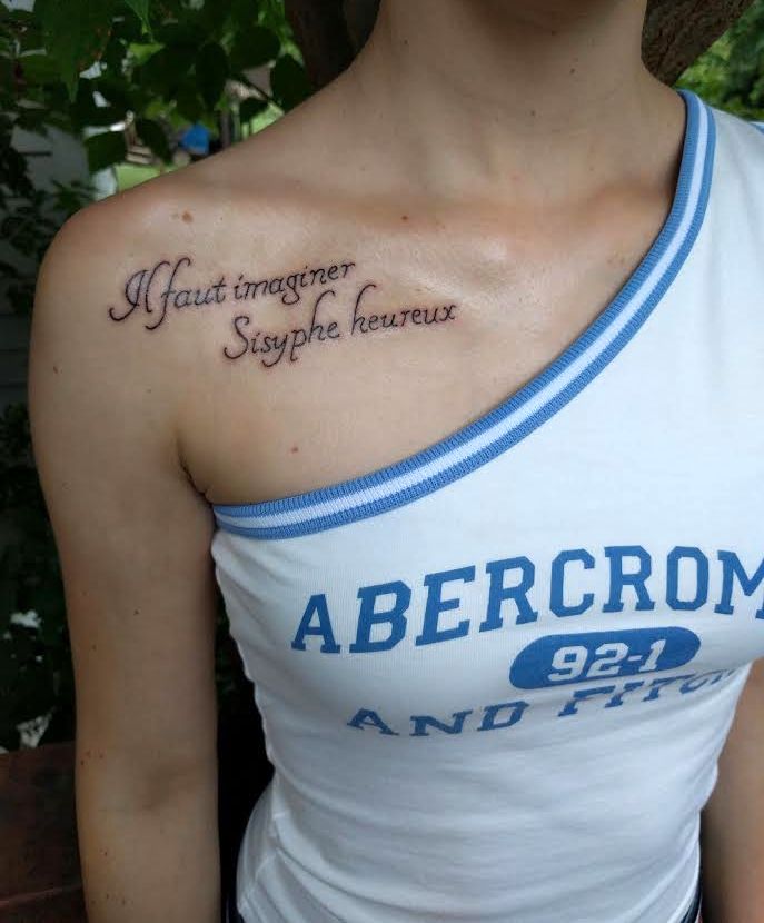 a woman with a tattoo on her shoulder that says abercrom and it's meaning