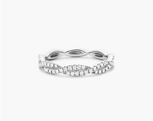 a white gold ring with diamonds on the sides and a curved design in the middle