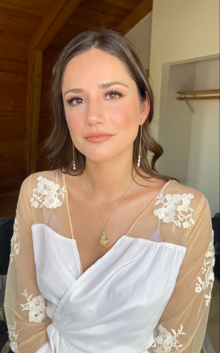 a woman in a white dress posing for the camera