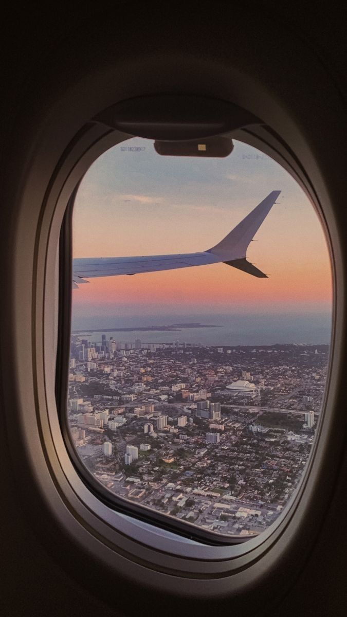 an airplane window looking out at the city