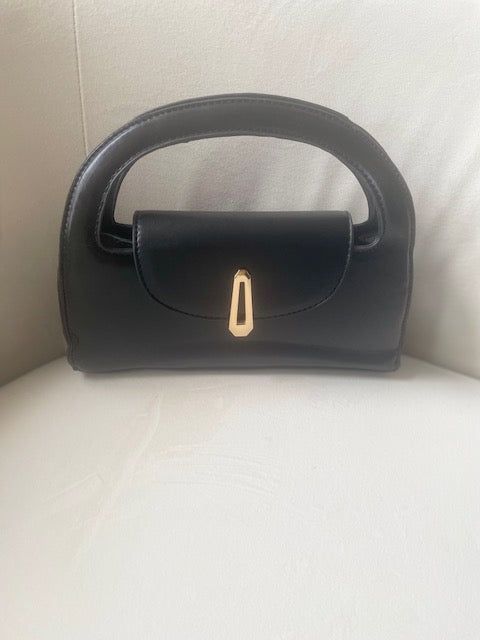 Elevate your fall wardrobe with the Margo Bag - the perfect accessory for any stylish outfit! This versatile bag offers both style and functionality, making it a fall must-have! PU Leather Imported Versatile Detachable Strap Gold Buckle Color: Black Approximate Measurements: 9.8"x4.7 Adjustable Handle Satchel Evening Bag, Versatile Handheld Bag With Detachable Strap, Chic Black Bags For On-the-go, Black Rectangular Hobo Bag With Adjustable Handle, Chic Satchel Bag For On-the-go, Chic Satchel With Removable Pouch And Double Handle, Chic Hobo Bag With Adjustable Handle, Chic Double Handle Satchel With Removable Pouch, Versatile Evening Baguette Bag With Detachable Handle