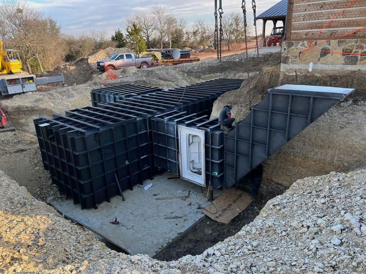 a construction site with several large black containers