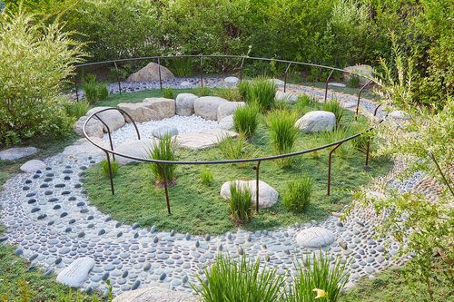 a circular garden with rocks and grass