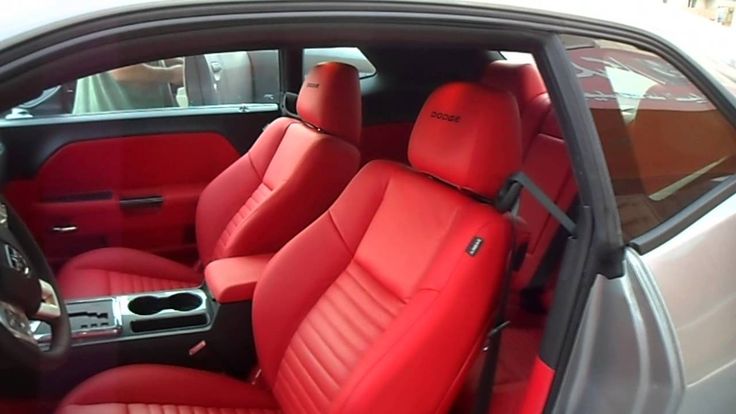 the interior of a car with red leather seats