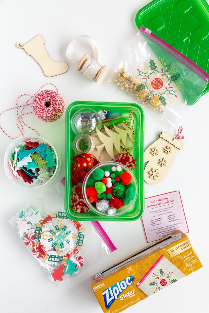 the contents of a christmas crafting kit laid out on a white surface with scissors and other items