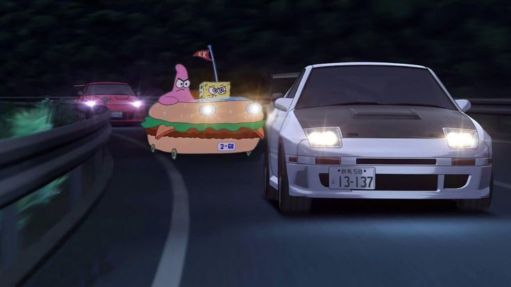 two cars driving down a highway with cartoon characters on the back of them at night