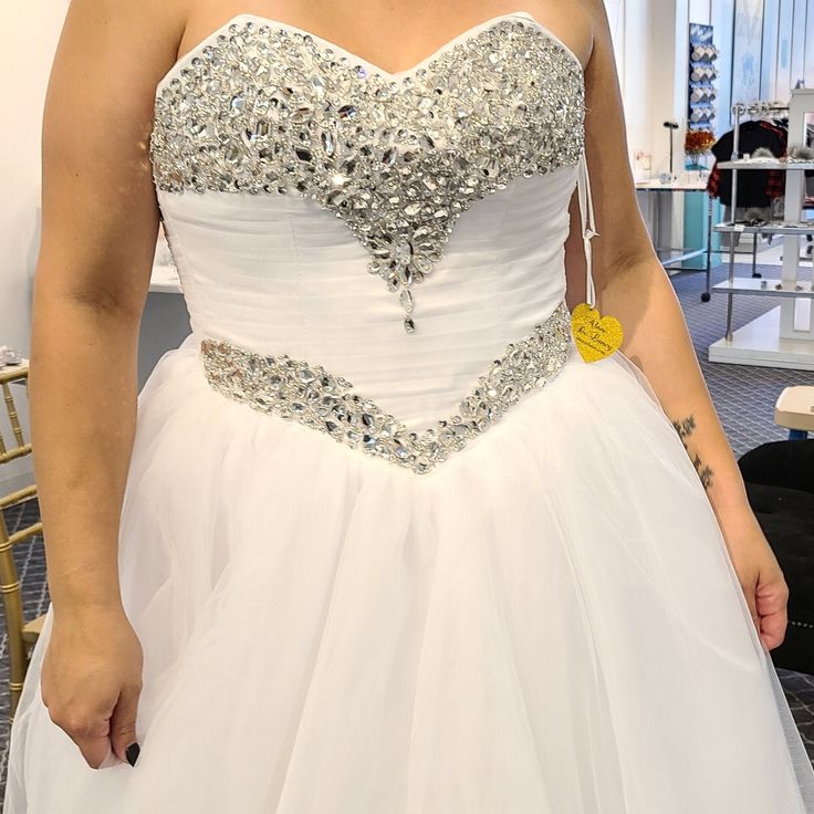 a woman in a white wedding dress posing for the camera with her hand on her hip