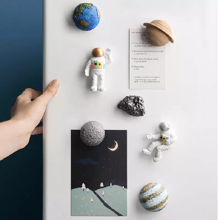 a refrigerator with magnets and space related items on it