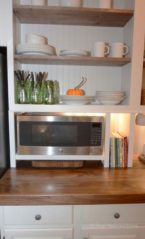 a microwave oven sitting on top of a wooden counter