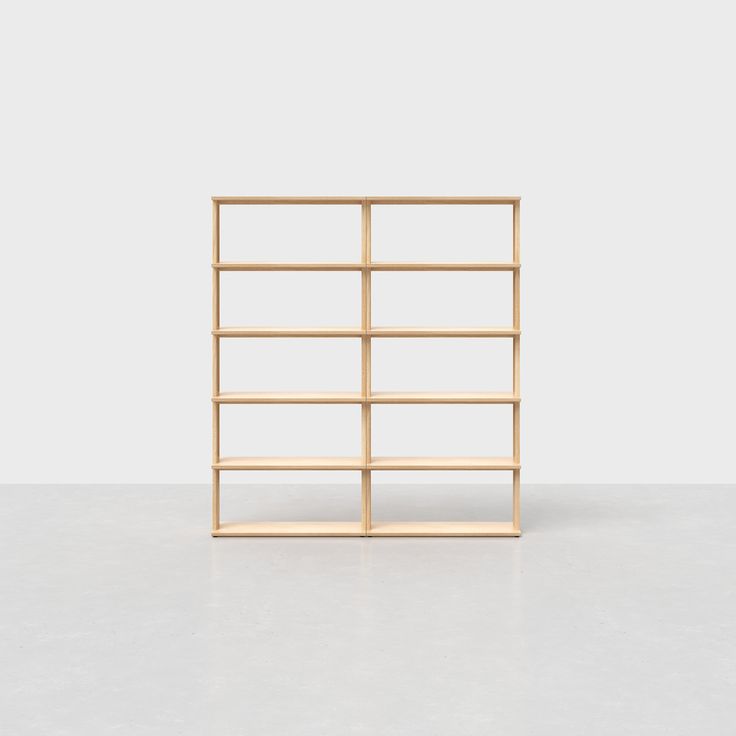 an empty wooden shelf sitting on top of a white floor