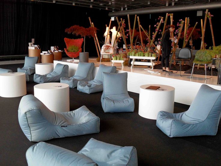 a room filled with lots of blue and white furniture on top of a black floor