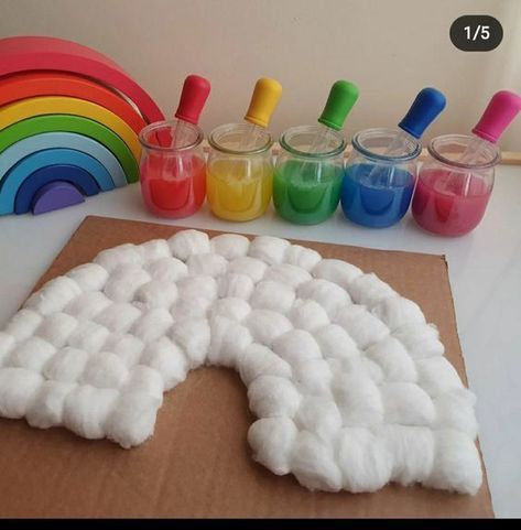 there is a cardboard box with paint and play dough in front of the rainbows