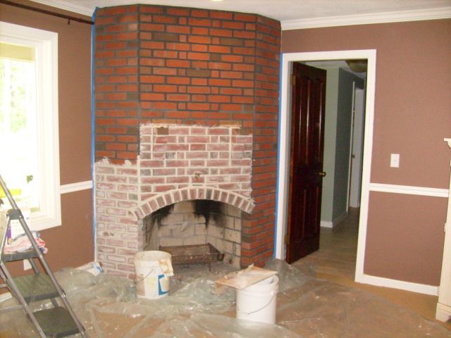 a brick fireplace is being installed in the living room