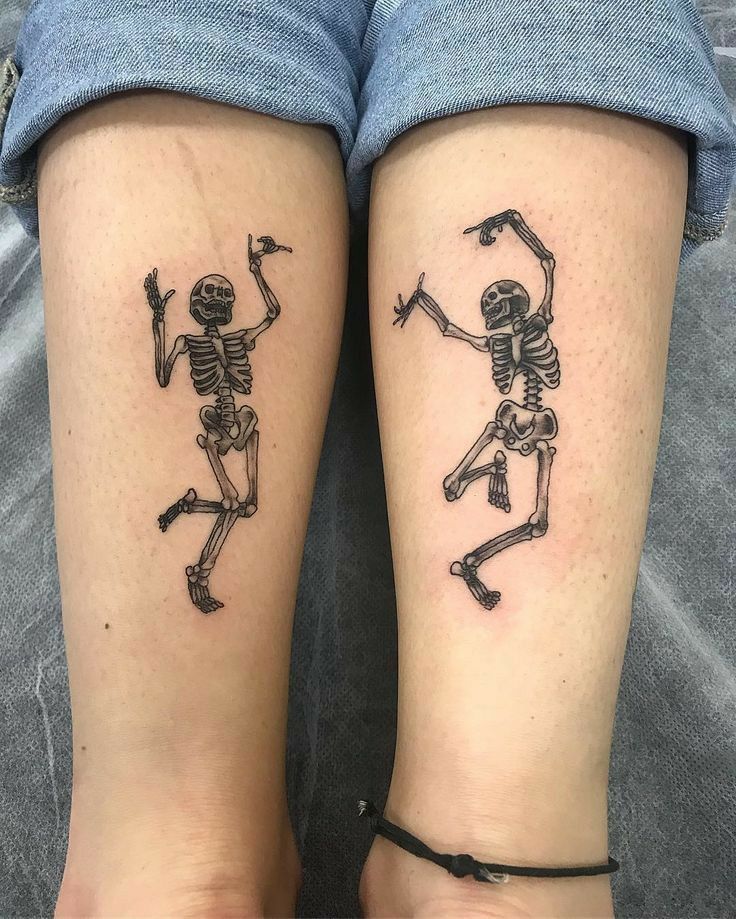 two people with matching tattoos on their legs