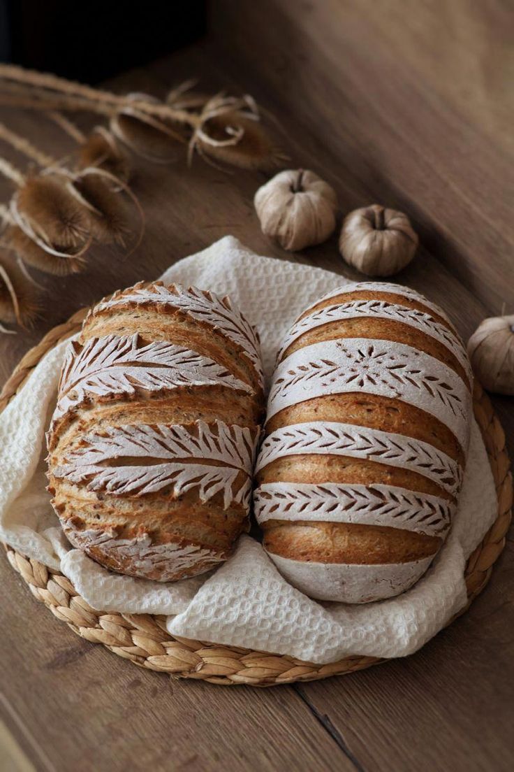 two loaves of bread sitting on top of a wooden table