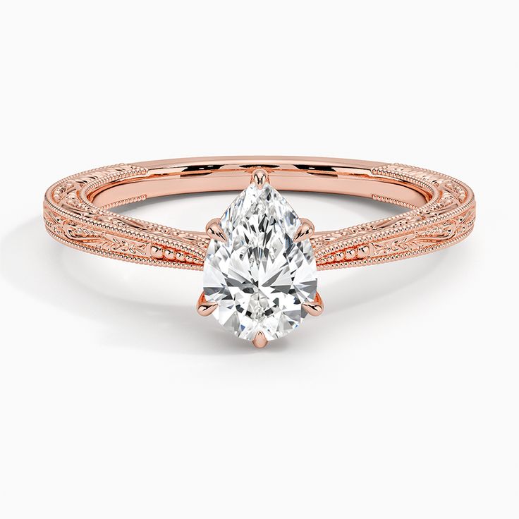 Pear Shaped Elsie Engagement Ring - 14K Rose Gold. This delicate vintage style setting is hand-engraved with ornate nature-inspired imagery and delicate milgrain on the top and sides of the band for a beautiful light-catching effect. A sizing bar in the back allows for future adjustments. Elegant 14k Gold Engraved Filigree Ring, Elegant Rose Gold Engraved Ring, Rose Gold Engraved Ring With Intricate Design, Elegant 14k Rose Gold Rose Cut Diamond Wedding Ring, Rose Gold Engraved Ring With Intricate Design For Wedding, Formal Rose Gold Engraved Ring With Intricate Design, Elegant Rose Gold Filigree Ring, Elegant Milgrain Engraved Ring For Anniversary, Elegant Engraved Milgrain Ring For Anniversary