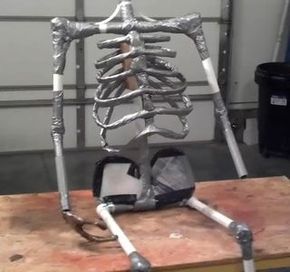 a metal skeleton sitting on top of a wooden table