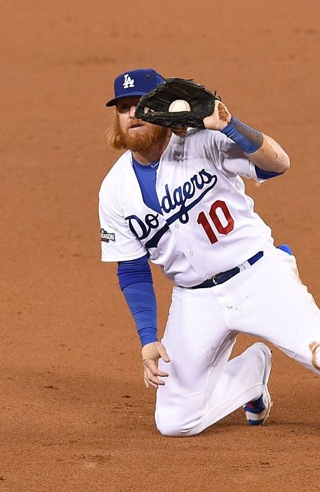 a baseball player kneeling down on the field