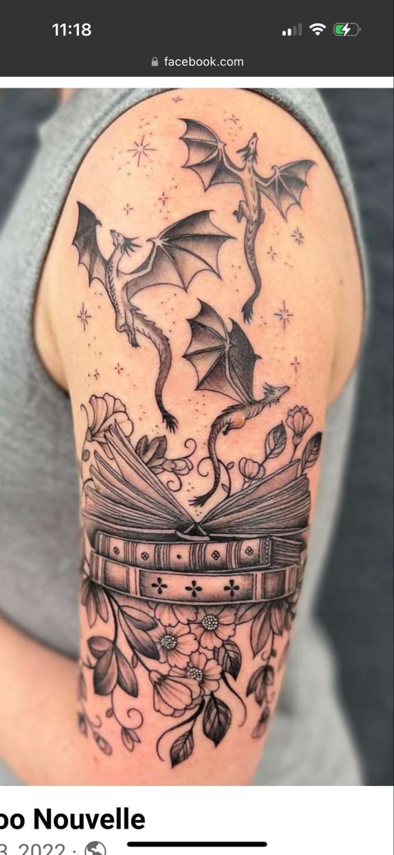 the back of a woman's shoulder with an open book and bats on it