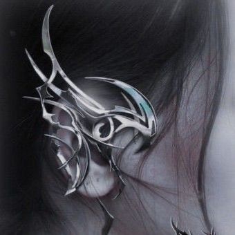 a drawing of a woman's face with an intricate design on the side of her ear