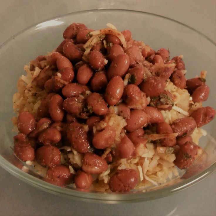 a glass bowl filled with beans and rice