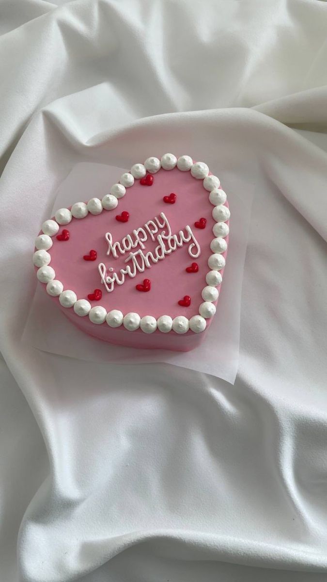 a heart shaped cake with happy birthday written on it