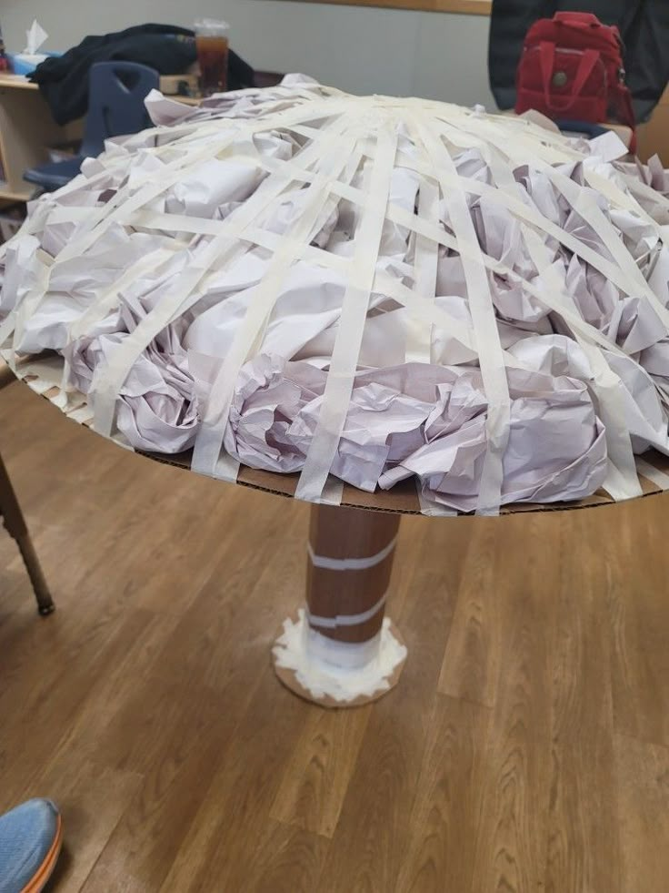 an umbrella made out of paper on top of a wooden table