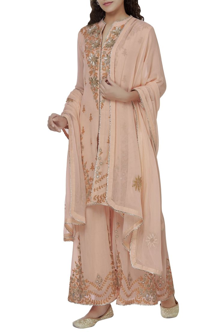 Floral motif placement work asymmetric kurta in peach paired with matching palazzo and dupatta.
Components: 3
Neckline: Band collar
Sleeve Length: Full sleeves
Fabric: Georgette
Color: Peach 
Dori,zari embroidery
Kurta: Side slits,V neckline
Closure: Sharara: Side zip and hook - Aza Fashions Asymmetric Kurta, Embroidery Kurta, Kurta Set For Women, Zari Embroidery, Band Collar, Kurta Set, Full Sleeves, Set For Women, Aza Fashion