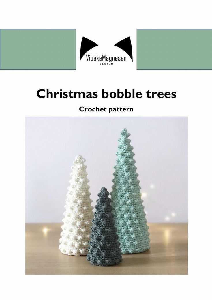 three crocheted christmas trees sitting on top of a table