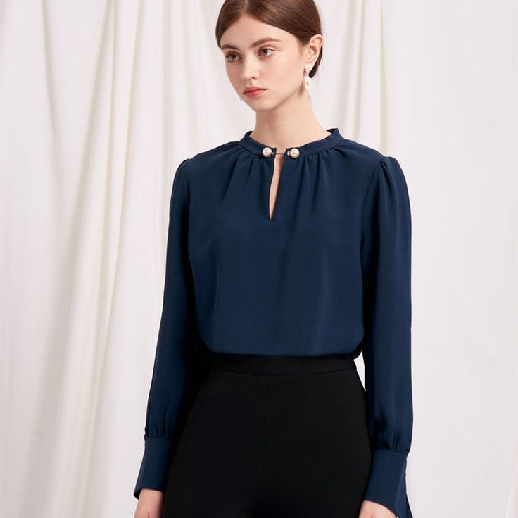 Everyone's favourite modern vintage style Buvette Pearl blouse now updated in a midnight-blue hue, featuring gently puffed sleeves, french cuffs and our signature pearl embellishment at the collar. Wear yours with a neutral coloured bottom and a bold red lip. Elegant Tops With Button Closure, Elegant Blouse With Button Closure And Collar, Elegant Blouse With Collar And Button Cuffs, Elegant Workwear Blouse With Pearl Buttons, Blue Blouse With Balloon Sleeves For Work, Office Blouse With Blouson Sleeves, Workwear Blouse With Blouson Sleeves And Collar, Collared Blouson Sleeve Blouse For Work, Elegant Blouse With Button Closure For Party