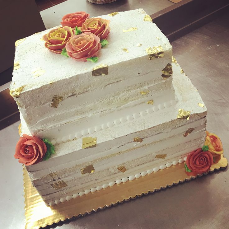 there is a three layer cake with flowers on it