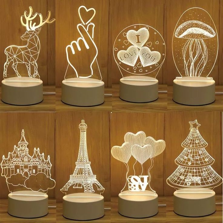 an assortment of different types of paper cut out animals and trees in front of a wooden wall