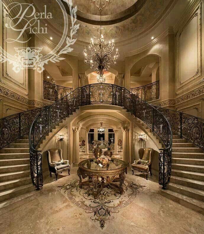 an elegant foyer with chandelier and marble flooring is pictured in this image