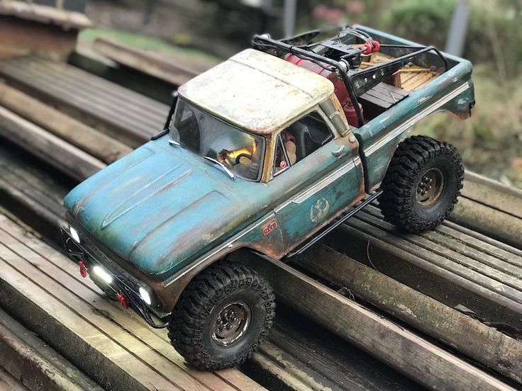 a toy truck is sitting on top of some wood