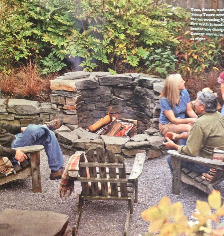 a group of people sitting around a fire pit