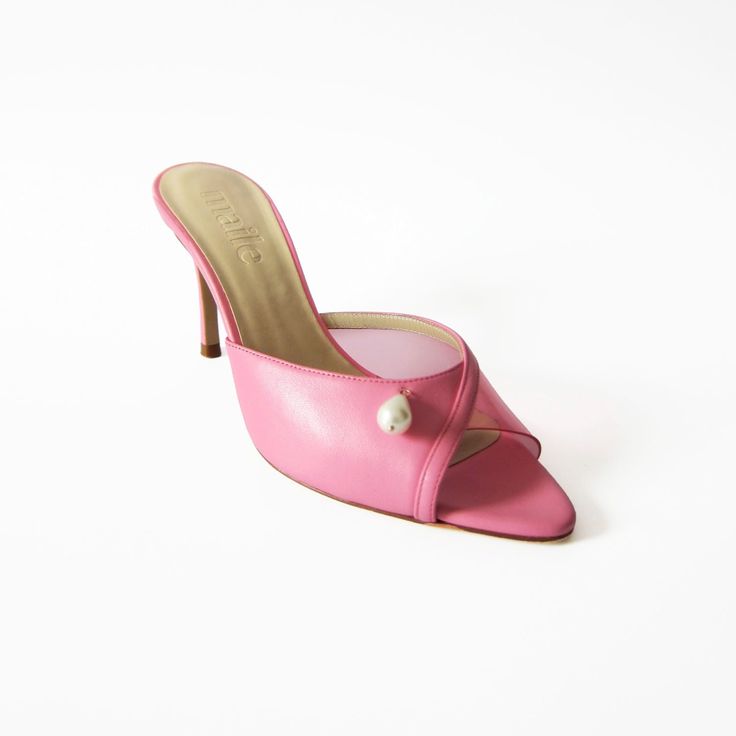 Elevate your footwear collection with Maile's Milly Pink Leather Heels, a true testament to elegance and luxury. These heels are meticulously crafted to offer both style and sophistication, perfect for making a fashion statement. With a pointed open toe and approximate heel height of 85mm/ 3. 35 inch, this style perfectly blends height and comfort. Adorned with a delicate pearl embellishment, these heels exude timeless style. Wipe clean Elegant 4-inch Kitten Heels With Single Toe Strap, Formal Sandals With Sculpted Heel And Almond Toe, Elegant Calf Leather Sandals With 4-inch Heel, Luxury Heels With Padded Open Heel, Calf Leather Heels For Gala, Luxury Wedding Shoes With 4-inch Heel, Pink Luxury Heels With Single Toe Strap, Luxury Closed Toe Kitten Heels With Heel Strap, Elegant Sandals With Sculpted Heel And Single Toe Strap