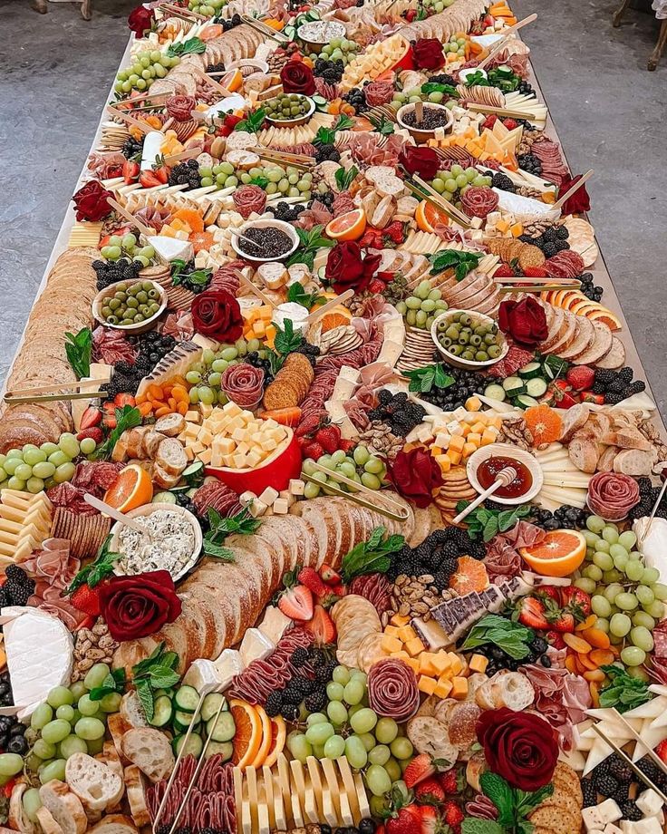 a long table filled with lots of different types of food on it's sides