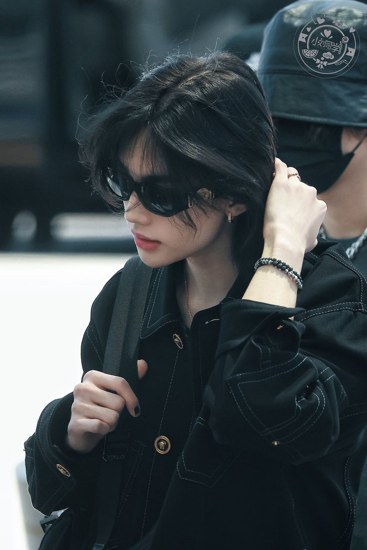 a woman wearing sunglasses and a black jacket