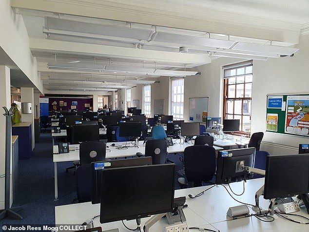 an office filled with desks and computer monitors