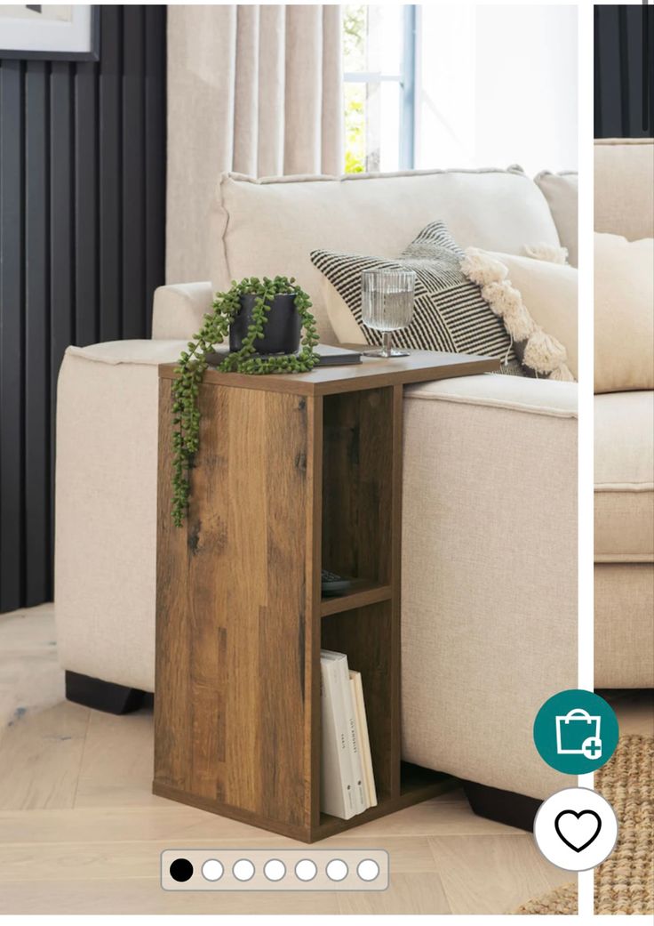 a living room with a white couch and wooden table in it's centerpiece