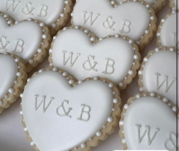 heart shaped cookies with the letters w & b and w on them are arranged in rows